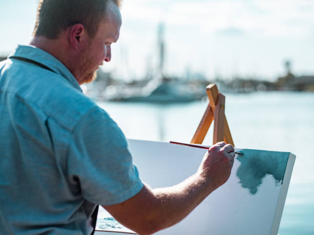 istock Man painting at the Lake shore 1269161565