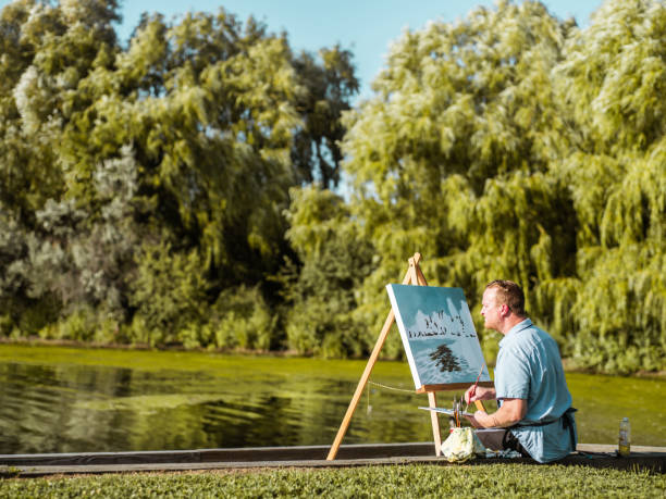 istock Man painting at the Lake shore 1269162290