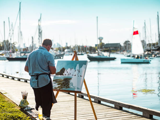 istock Man painting at the Lake shore 1269162492