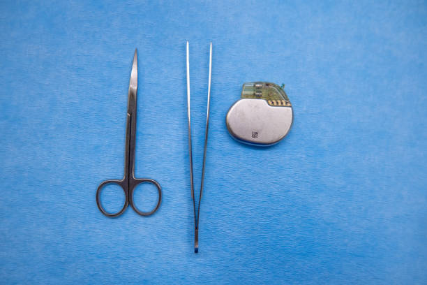 istock pacemaker, scissors and tweezers on a blue surgical pad 1269163369
