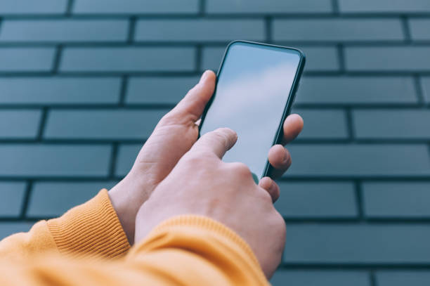 istock Mock-up technology. Man holds a smartphone in his hands close-up. 1269163579
