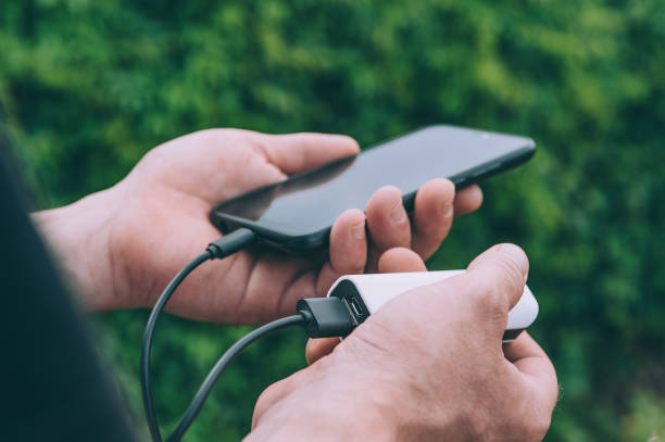 istock The guy charges a smartphone through a portable charger. 1269163627