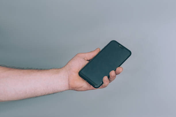 istock Mock-up technology. Man holds a smartphone in his hands close-up. 1269163629