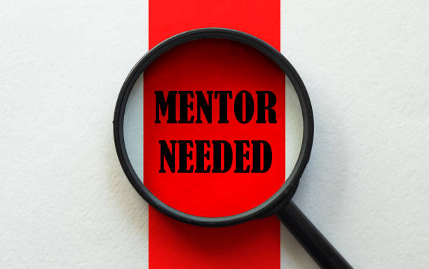 istock magnifier with text Mentor Needed on the white and red background 1269165002