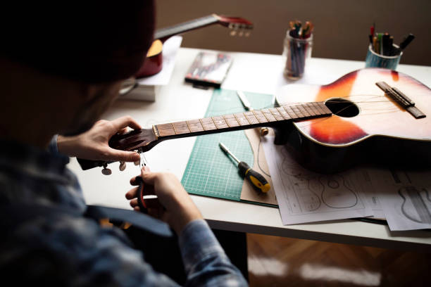 istock Final steps in repairing a guitar 1269166213