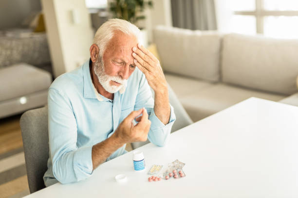 istock Worried senior man taking medicine. 1269168030
