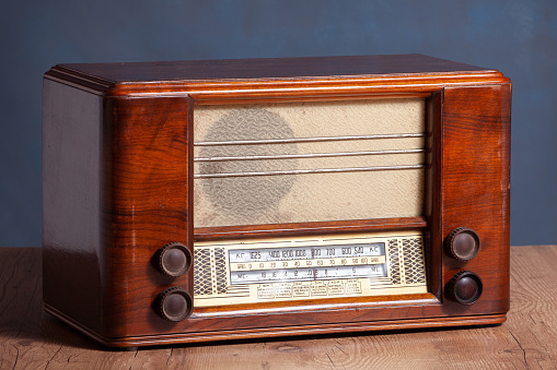 vintage radio on top of a wooden floor.