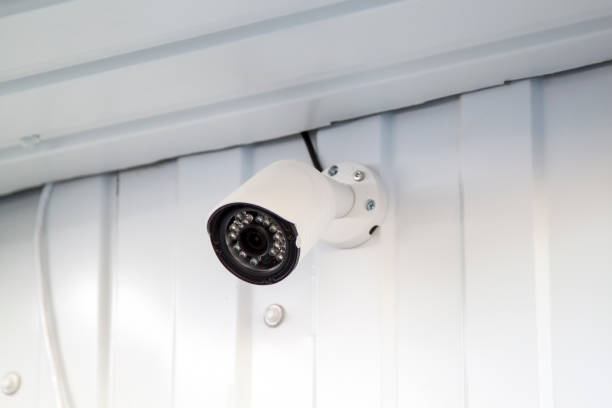 istock white CCTV surveillance camera mounted on wall of building 1269172493