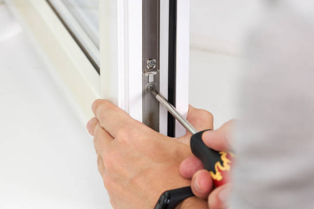 istock handyman adjusting white pvc plastic window indoors. worker using screwdriver to repair upvc window. homework maintenance 1269173411