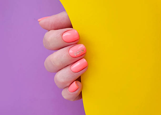 istock female hand beautiful manicure on a colored background 1269174298