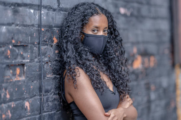 istock African American woman wearing a protective face mask 1269174440