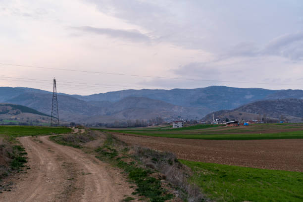 Village and dirt road view at sunset