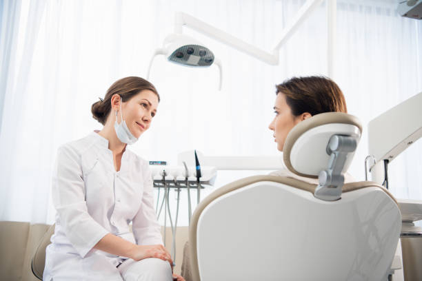 istock A young woman explaining her dental problem to her doctor, the d 1269177325