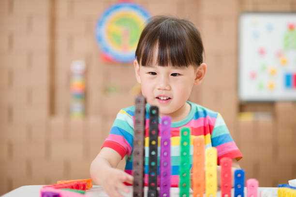 istock young girl play number sticks for home schooling 1269178304