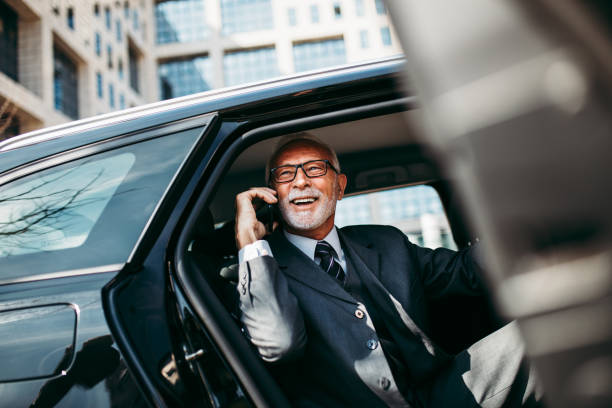 uomo d'affari senior in auto - car driving men business foto e immagini stock