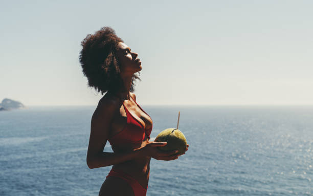istock Girl with coconut sunbathing 1269191682