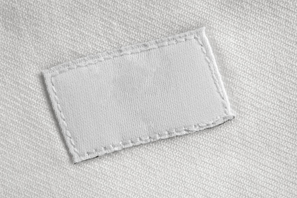 white blank laundry care clothes label on cotton shirt background - scale industry copy space special imagens e fotografias de stock