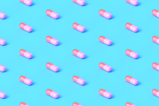 青い背景にシームレスな反復カプセルの丸薬 - vitamin capsule 写真 ストックフォトと画像