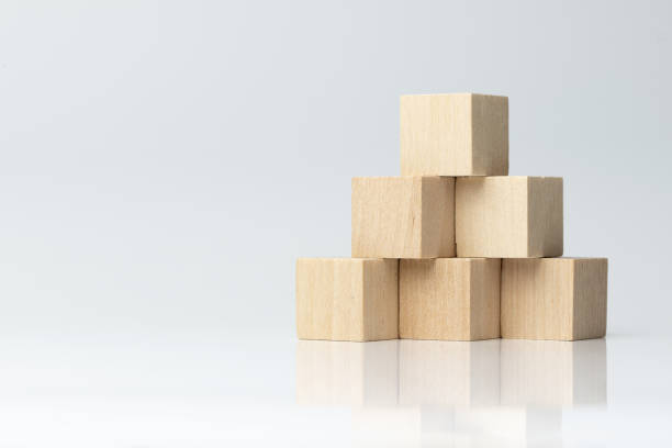 Six wooden blocks arranged in pyramid shape Six wooden blocks arranged in pyramid shape isolated on white background toy block photos stock pictures, royalty-free photos & images