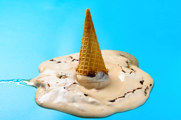 istock side view melted milk tea flavor ice cream cone on a blue background 1269204516