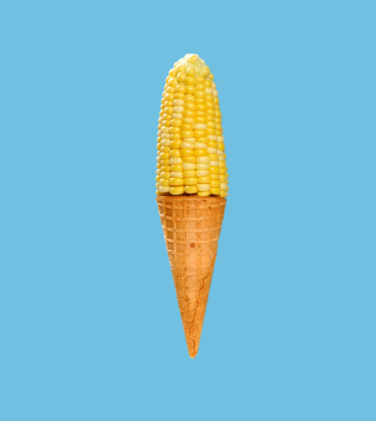 maize and an empty cone shaped like an ice cream cone on blue background at square composition