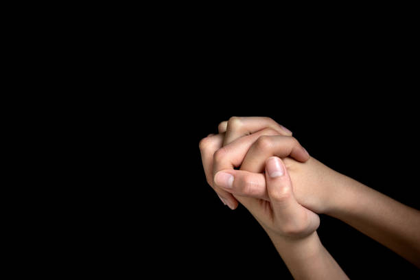 istock Praying hands is in the dark 1269206776