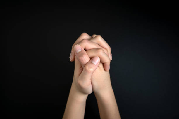 istock Praying hands is in the dark 1269206783