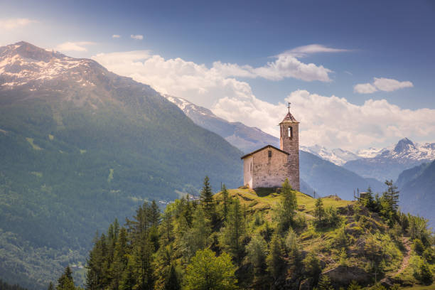 church in idyllic alpine landscape at springtime near la rosiere – french alps - sunrise european alps mountain alpenglow imagens e fotografias de stock