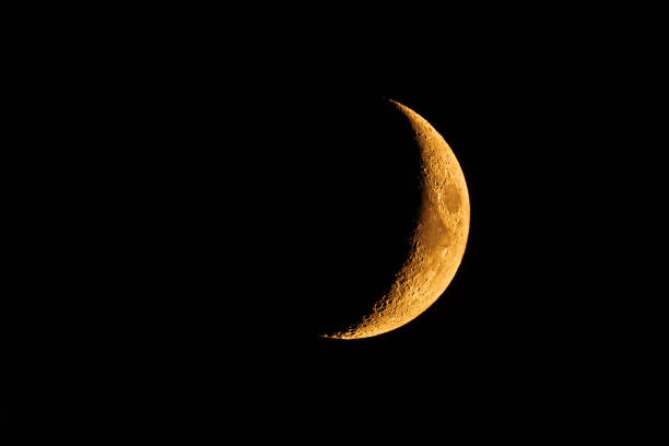 Orange colored waxing crescent moon Orange colored waxing crescent moon; the orange glow is the result of the smoke coming from the wildfires burning all aver the San Francisco Bay Area, California crescent photos stock pictures, royalty-free photos & images