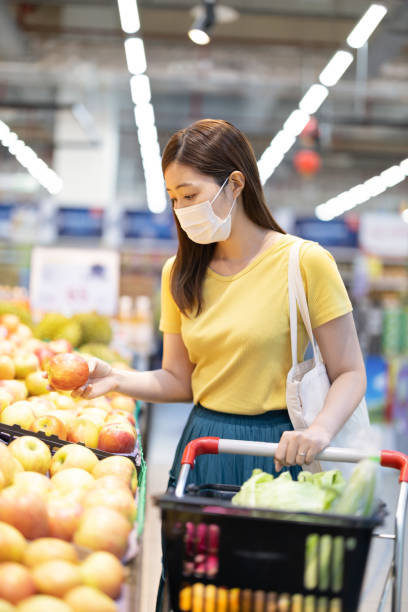 istock asian woman picks up apple 1269230140