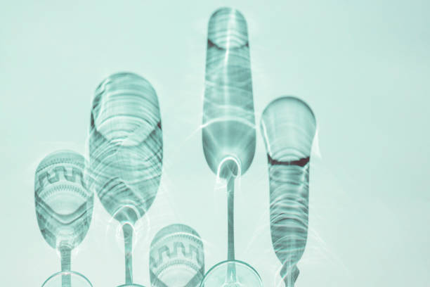 Wine glasses on a sunny table cast shadows, sunlight, crystal glassware, wine glasses, champagne flute.
