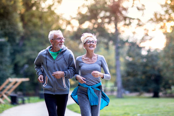 istock Aged couple jogging in the public park and smile 1269241721