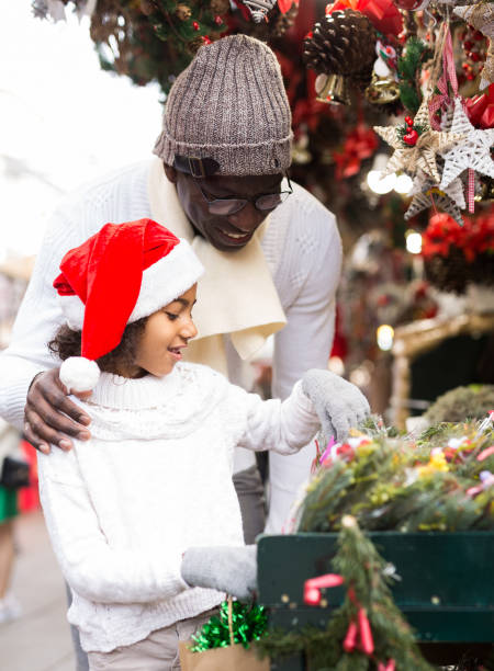 istock Man with daughter choosing Christmas tree leaves and decorations 1269244510