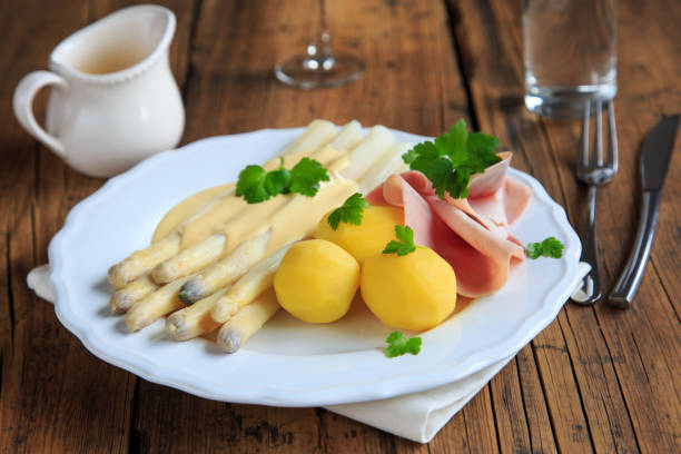 asparagus with ham and potatoes stock photo