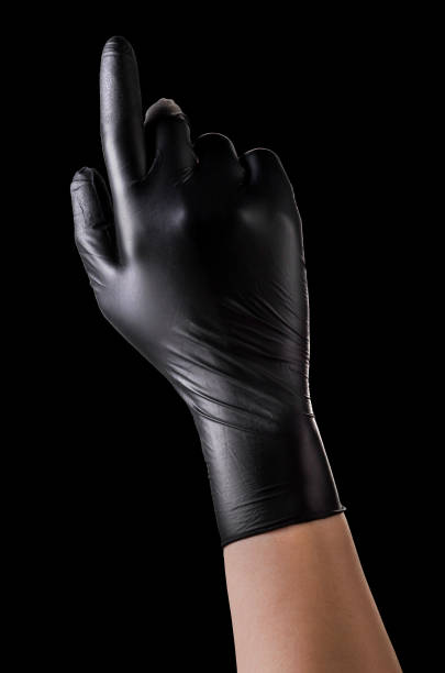 istock Hand in black gloves with the index finger pointing up on black 1269247698