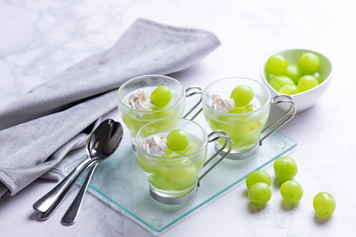 Homemade grape jelly in a glass. Cool dessert for summer.