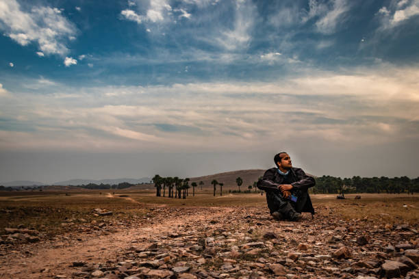 istock man sitting on ground in isolated loneliness 1269249836