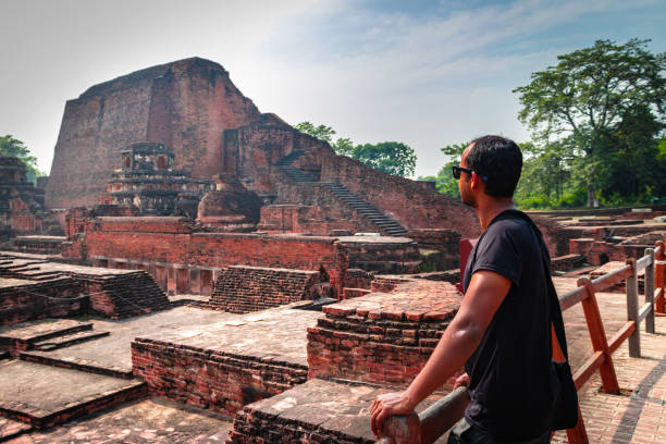 man posing at historical sites of nalanada ruins