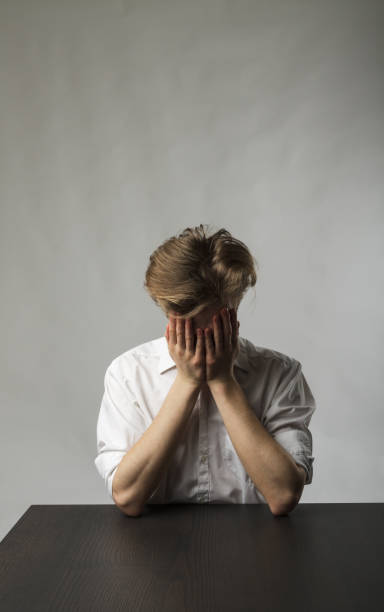istock Tired young man. Overtime and fatigue concept. 1269249895