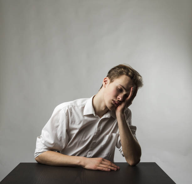 istock Tired young man. Overtime and fatigue concept. 1269249897