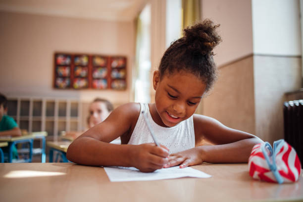 istock Smiling schoolgirl is taking a test 1269251457