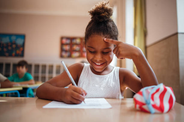 istock Smiling schoolgirl is taking a test 1269251485