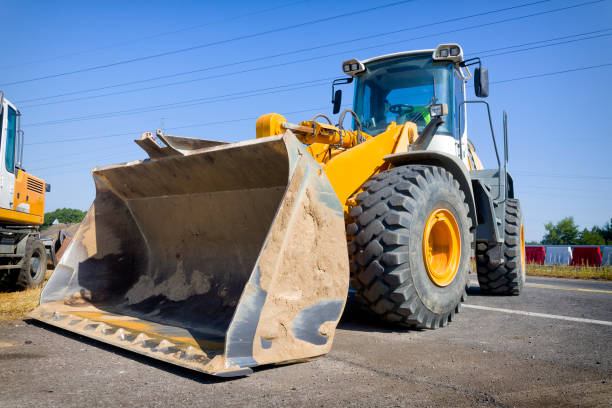istock Yellow earth mover on a highway construction site 1269254193