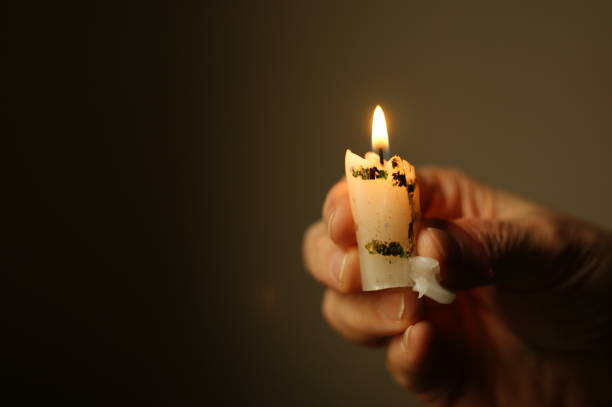 istock flame of a small burnt candle. candle flame with black background 1269254237