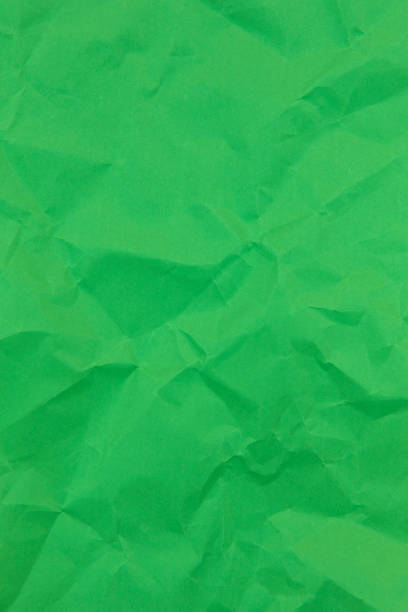 istock Textured crumpled green paper background. Copyspace 1269257224