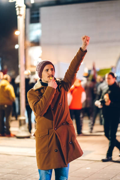 istock Man leading city riots 1269258406