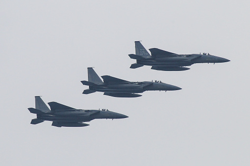 On 02/20/2013 in Okinawa, Japan by Kadena air force base 3 F-14 US Military aircraft flying low over Okinawa.