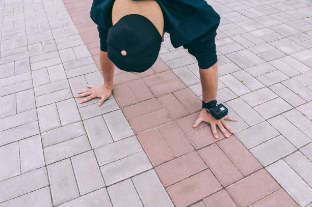 istock B-boy Break Dancer stands on his hands upside down with an action camera. 1269262688