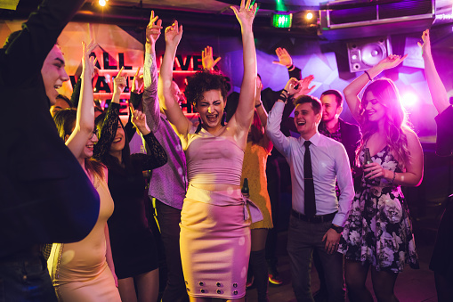 Group of people dancing and having fun at a New year's party.