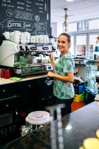 istock Female barista preparing coffee machine 1269264562